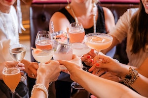 people clinking glasses in a toast